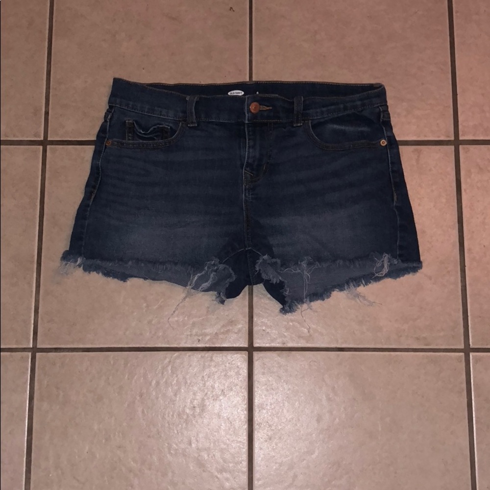 Denim shorts that are ripped at the bottom